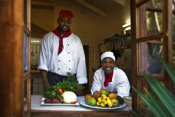 Chefs with fresh produce from the garden