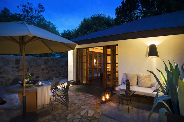 Heliconia Suite terrace lit by lanterns at dusk
